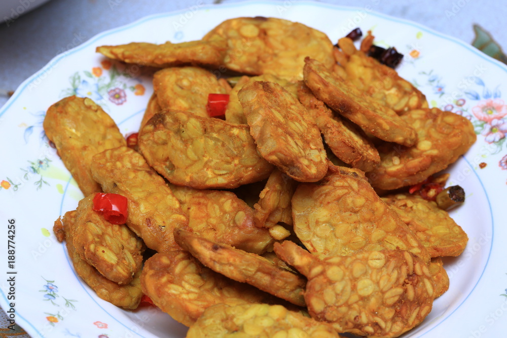 Famous Javanese cuisine food : Tempe or Tempeh made of fermentation process that binds soybeans into a cake form, sliced and fried. Famous in Indonesia and Malaysia Famous Javanese cuisine food : Tempe or Tempeh made of fermentation process that binds soybeans into a cake form, sliced and fried. Famous in Indonesia and Malaysia