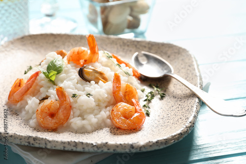 Plate with tasty seafood risotto on table