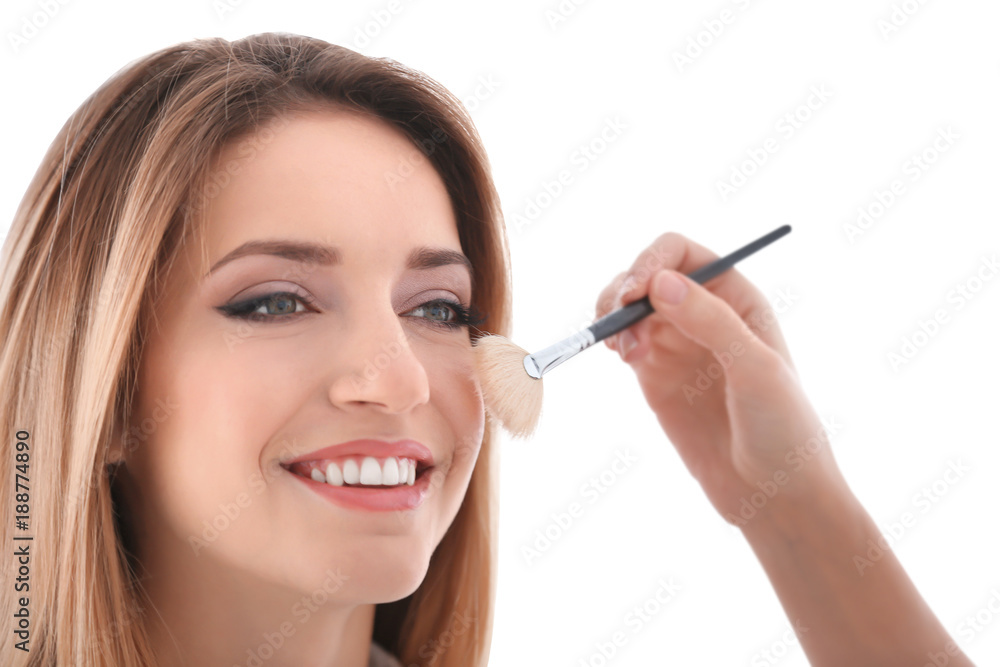 Professional artist creating makeup for model on white background Professional artist creating makeup for model on white background