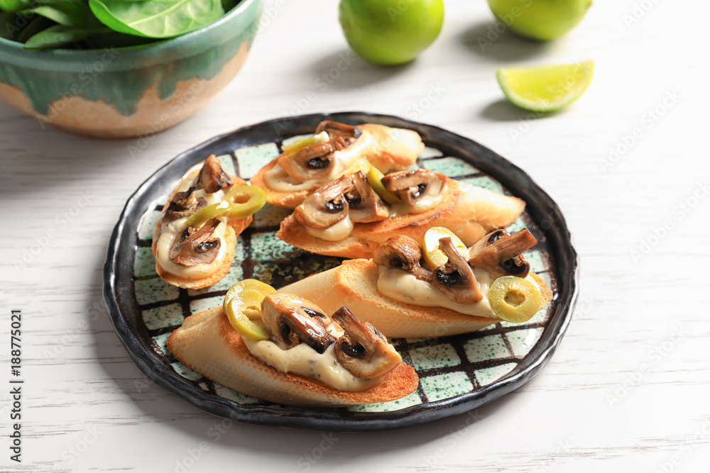Tasty bruschettas with mushrooms on plate