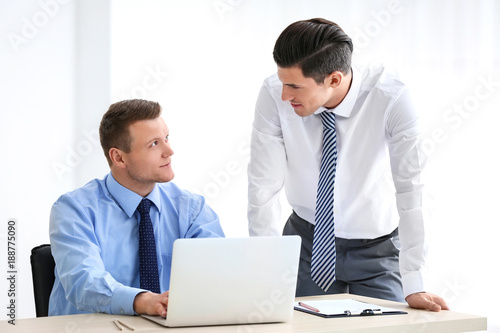Young men with laptop on li...