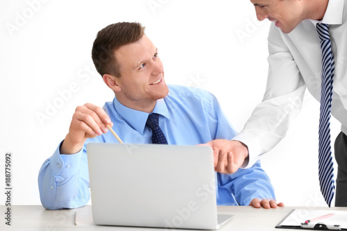 Young men with laptop on li...