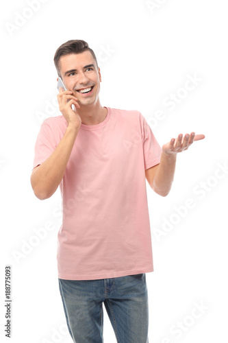 Attractive young man talking on mobile phone on white background