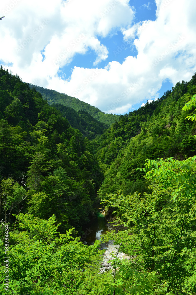 Mountain area in Japan,Sky and mountains and clear water river flowing through the valley