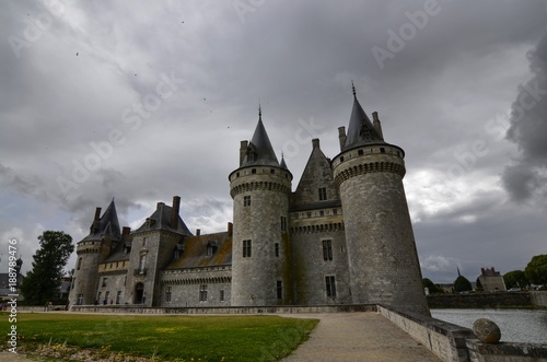 Castle of Sully-sur-Loire, Loire region, France. Snap of 30 June 2017 at 18:21. Captured at the entrance of the castle park. White clouds moving on blue sky. Towers well visible in the image.