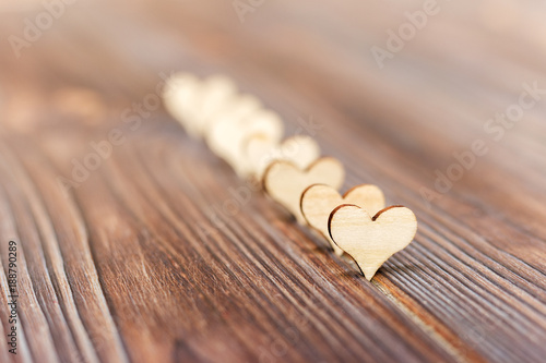wooden hearts forming a side border on a rustic wood background Valentines Day