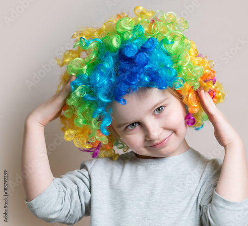 Portrait of little girl in colourful wig