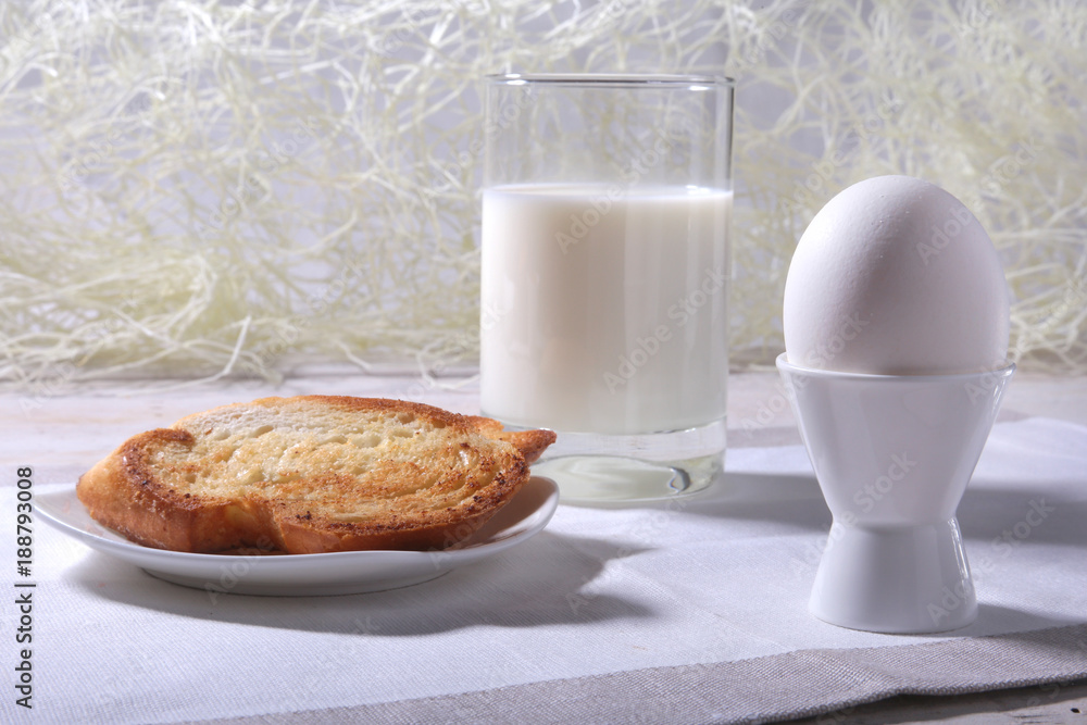 Morning Breakfast set with egg, orange jam on bread toast and milk in glass. Morning Breakfast set with egg, orange jam on bread toast and milk in glass.