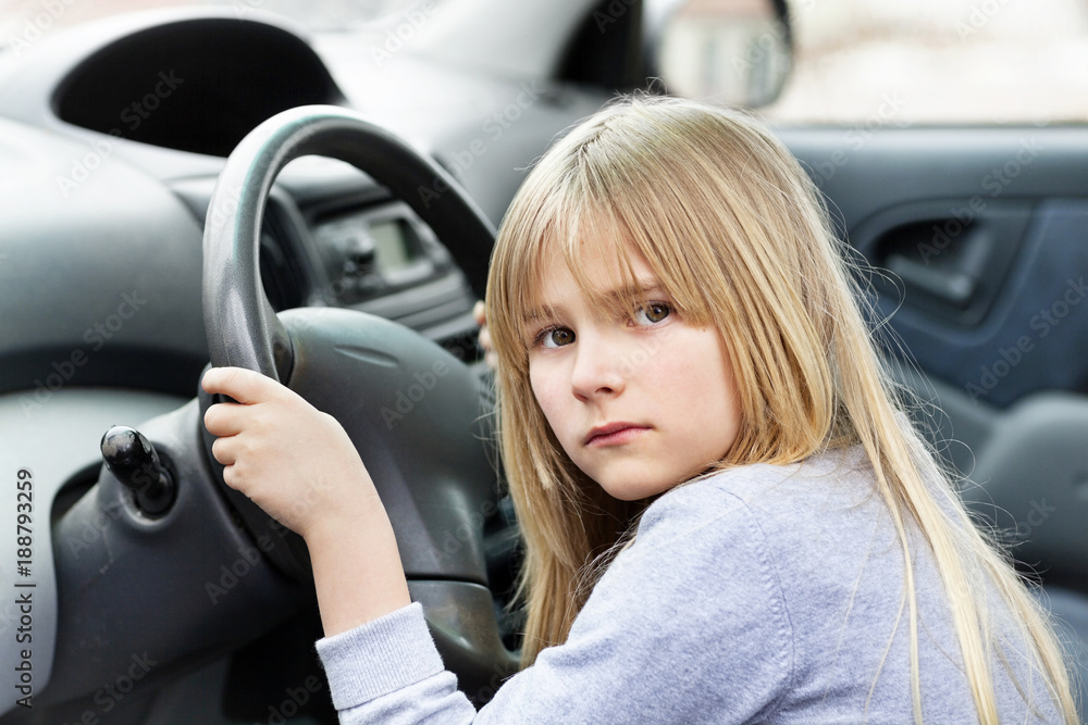 Little blond girl behind steering wheel Little blond girl behind steering wheel