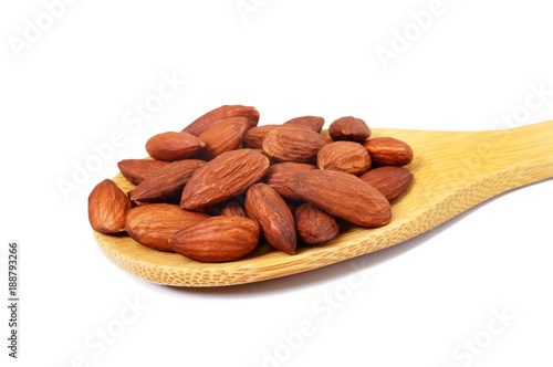 Almonds in a wooden spoon isolated on white background. Close-up.