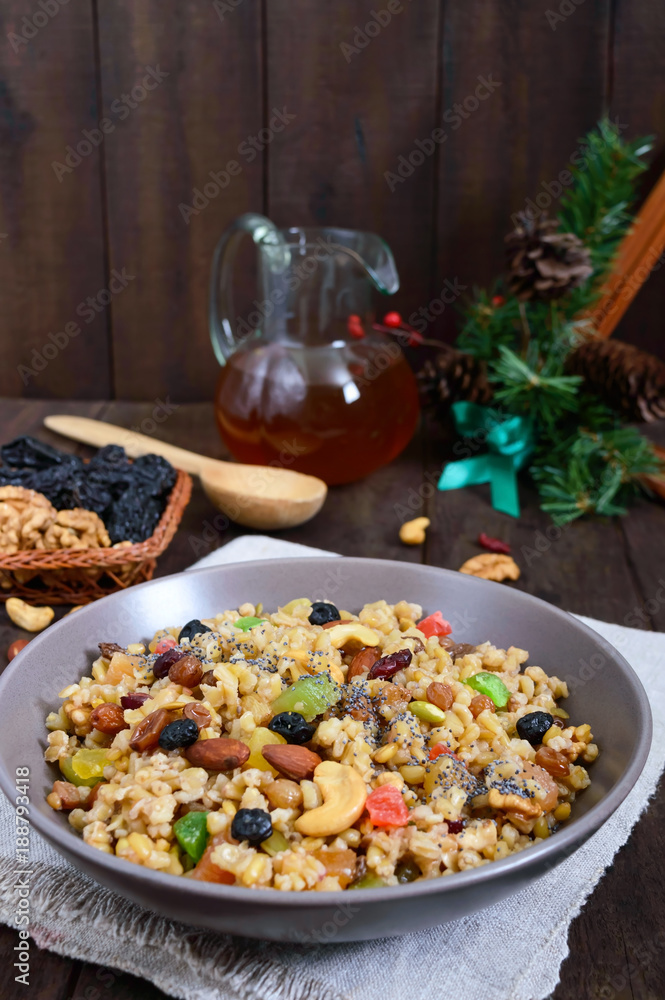 Wheat porridge with nuts, dried berries, raisins, poppies in a ceramic bowl on a dark wooden background. Proper nutrition. Healthy food. Wheat porridge with nuts, dried berries, raisins, poppies in a ceramic bowl on a dark wooden background. Proper nutrition. Healthy food.