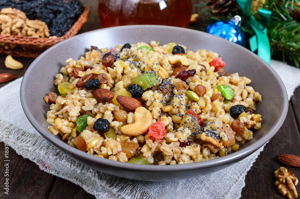 Wheat porridge with nuts, dried berries, raisins, poppies in a ceramic bowl on a dark wooden background. Proper nutrition. Healthy food. Wheat porridge with nuts, dried berries, raisins, poppies in a ceramic bowl on a dark wooden background. Proper nutrition. Healthy food.