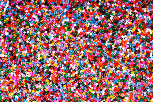 Background of multicolored decorative plastic craft beads. 
