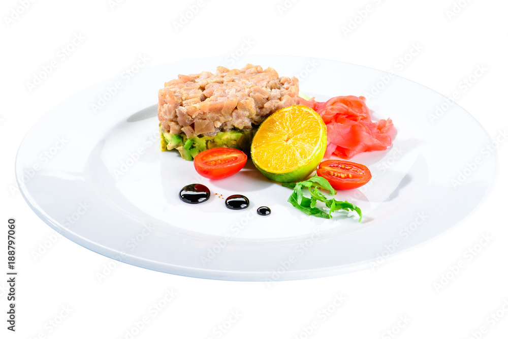 Tasty Tuna Tartare with lime, ginger and avocado in a white plate isolated on white background, close-up Tasty Tuna Tartare with lime, ginger and avocado in a white plate isolated on white background, close-up