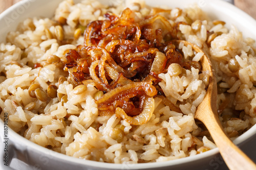 Arab food: Mujaddara from rice and lentils with caramelized onion close-up. horizontal photo
