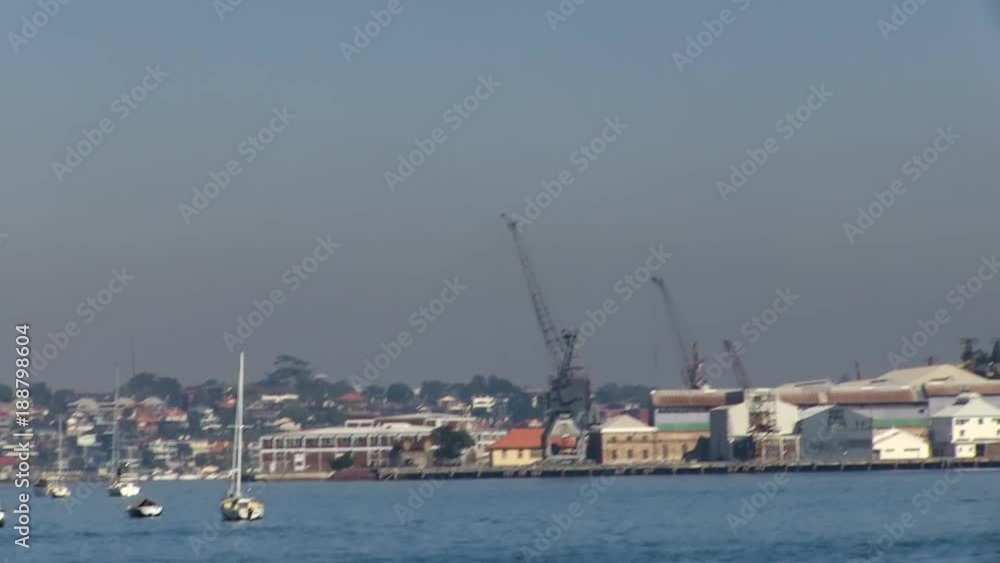 A medium shot of buildings and boats. Camera pans to the left. A medium shot of buildings and boats. Camera pans to the left.