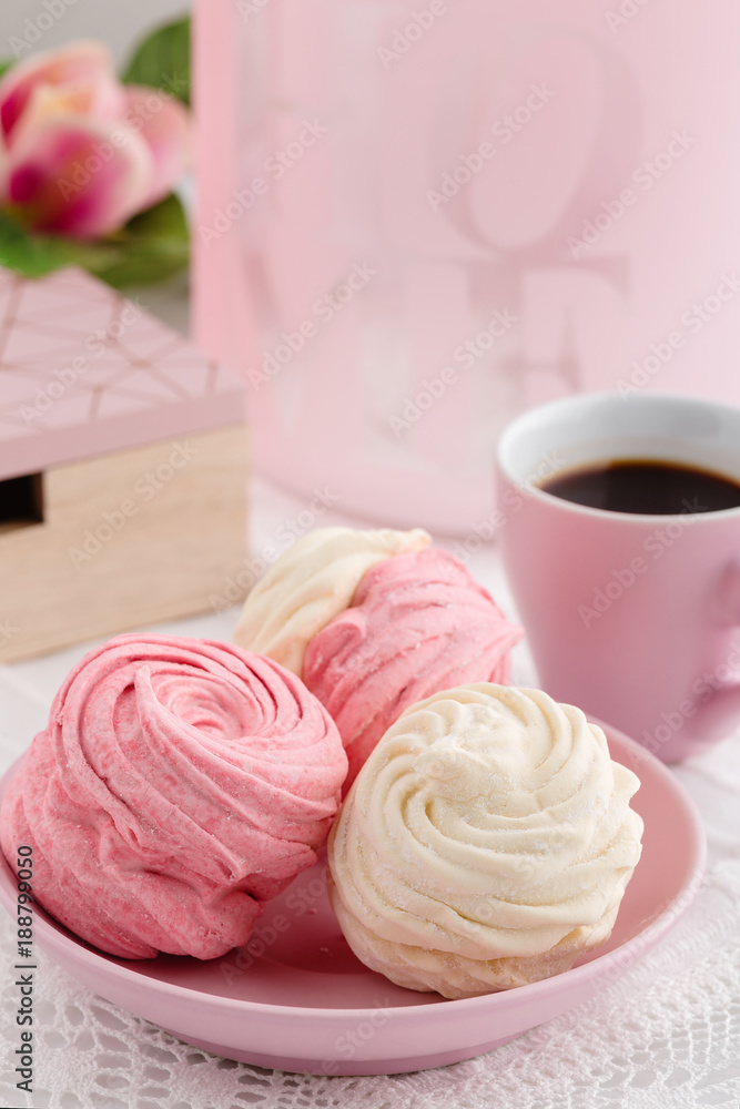 Homemade zephyr or marshmallow with coffee on pink background Homemade zephyr or marshmallow with coffee on pink background