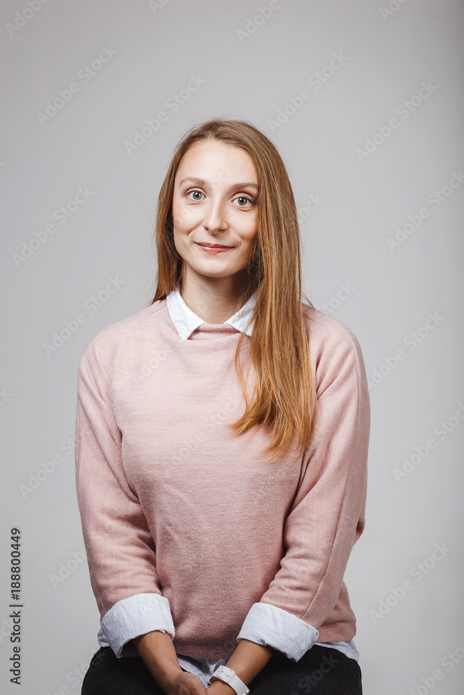 pretty woman wear wool knitted sweater and casual shirt sitting on a chair in studio. pretty woman wear wool knitted sweater and casual shirt sitting on a chair in studio.