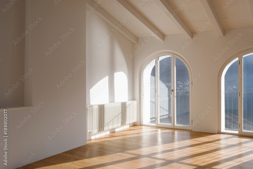 Empty room with large windows and antique beams Empty room with large windows and antique beams