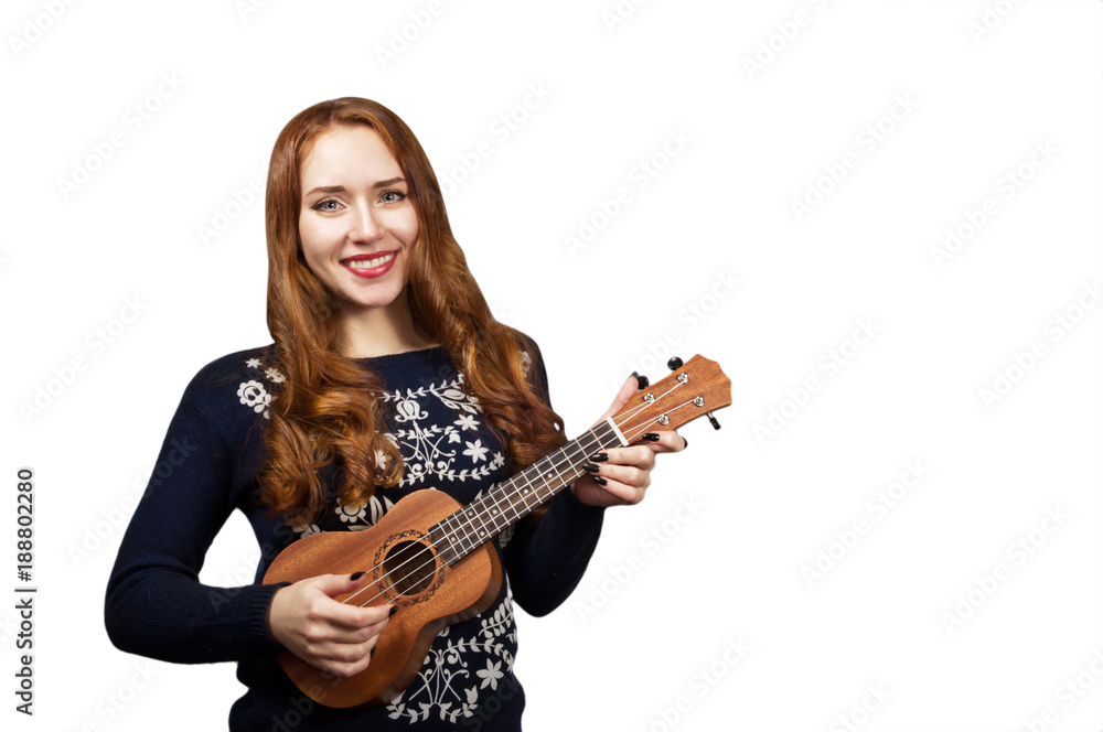 Red-haired girl play on the ukulele isolated on white. Red-haired girl play on the ukulele isolated on white.
