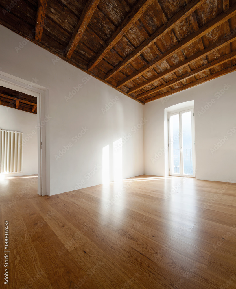 Empty room with large windows and antique beams Empty room with large windows and antique beams