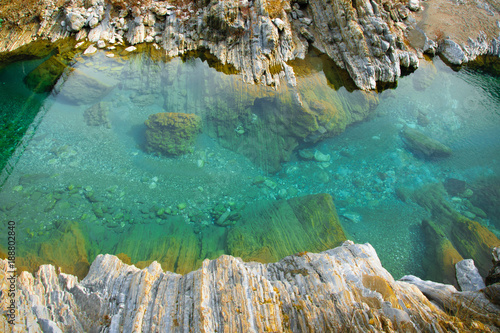Areal view  of pure turquoise river water and white rocks. Natural background with space for text