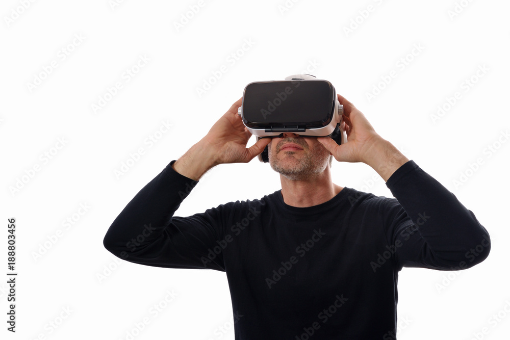 Smiling man with vr glasses holding glasses looking up isolated