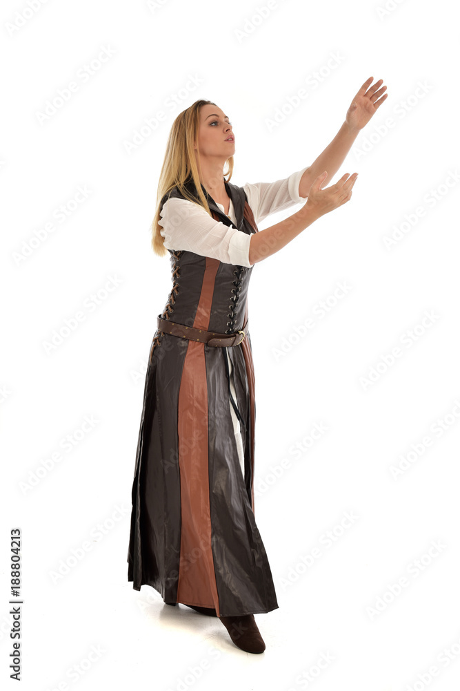full length portrait of girl wearing brown fantasy costume. standing pose on white studio background. full length portrait of girl wearing brown fantasy costume. standing pose on white studio background.