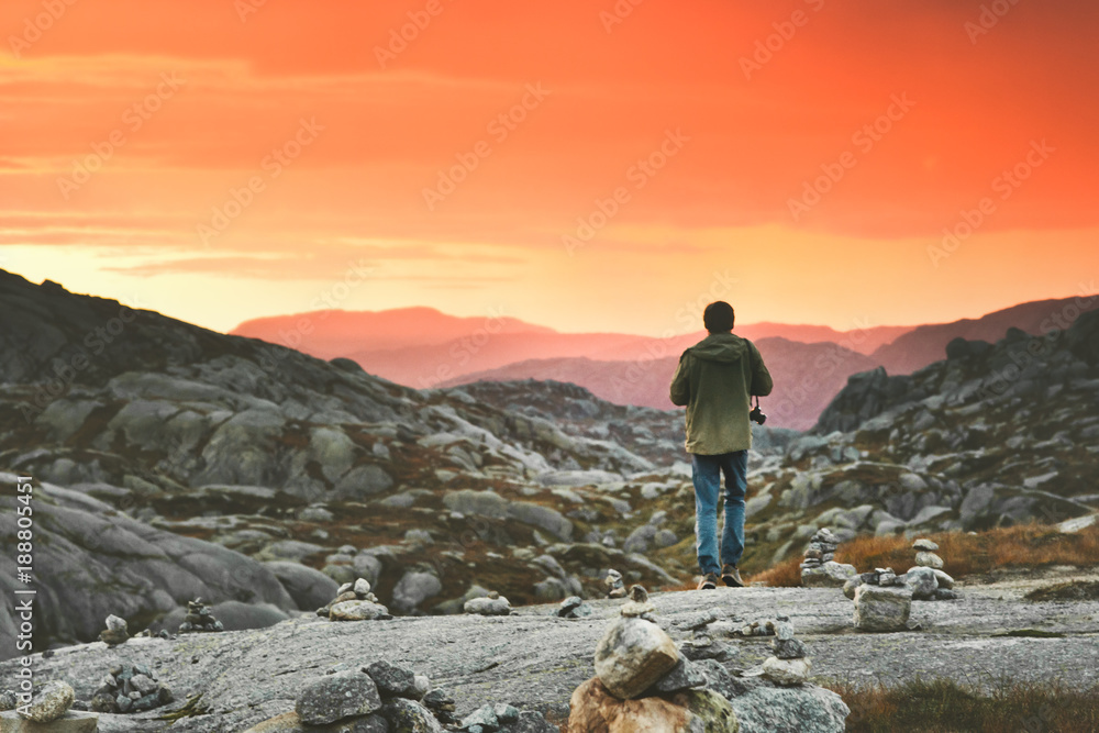 Travel Man walking enjoying sunset mountains landscape in Norway Lifestyle adventure vacations outdoor sky natural colors