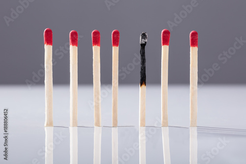 Burnt Matchstick Separated By Red Matchsticks