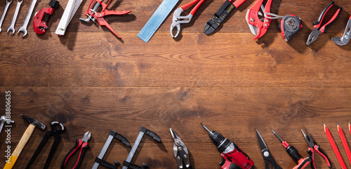 Various Worktools In A Row On Wooden Desk photo