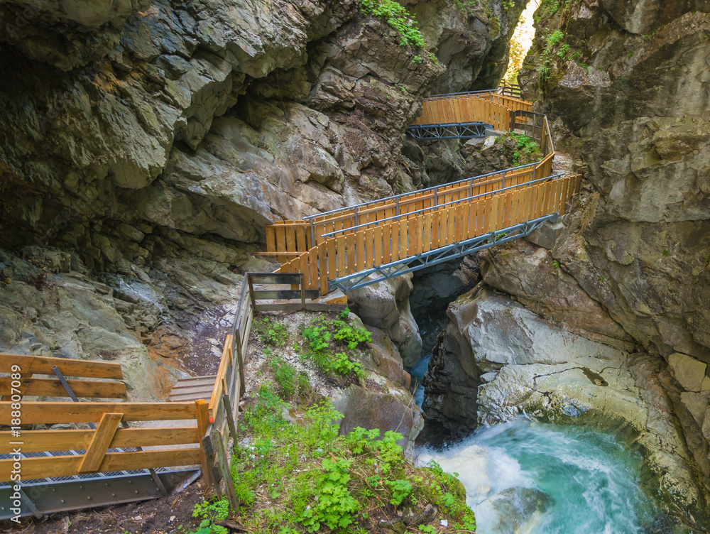 Fototapeta premium Waterfalls Stanghe (Gilfenklamm) localed near Racines, Bolzano in South Tyrol, Italy. Wooden bridges and runways lead through the canyon and give a spectacular sight to the waterfalls.