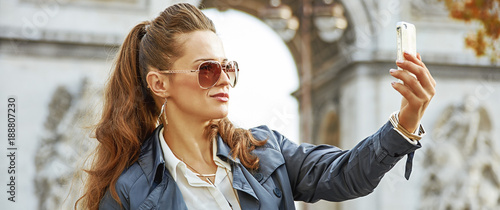 fashion-monger in Paris, France taking selfie with phone photo