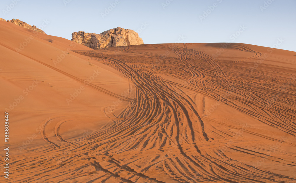 tyre tracks inthe desert at sunrise