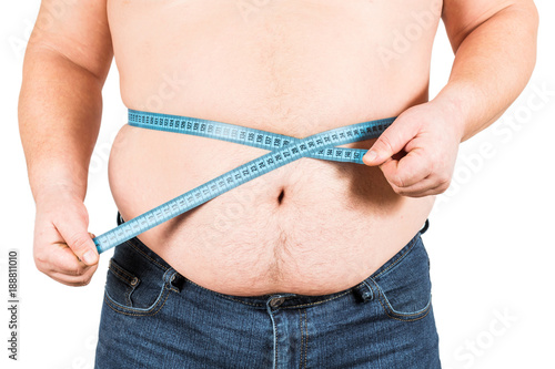 Man measuring his fat belly with measurement tape