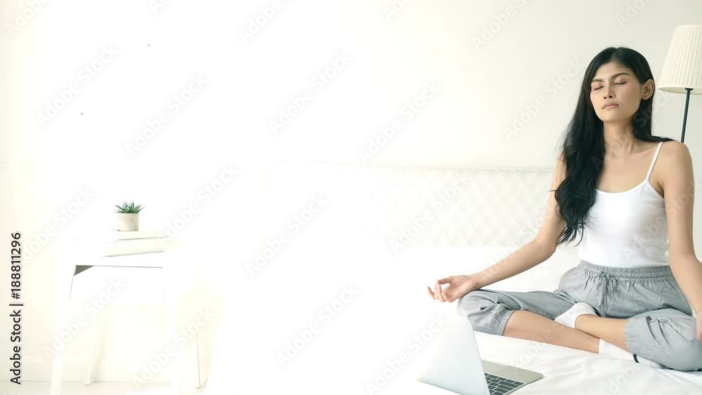 Asian woman using laptop for record video. Woman have a yoga class for online cause. 