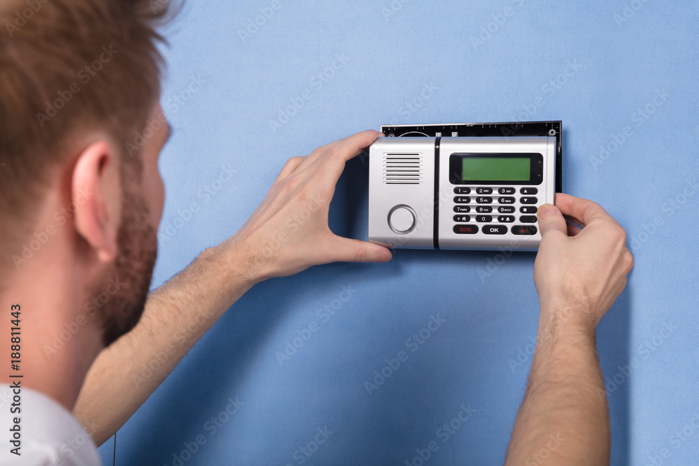 Human Hand Installing Security System