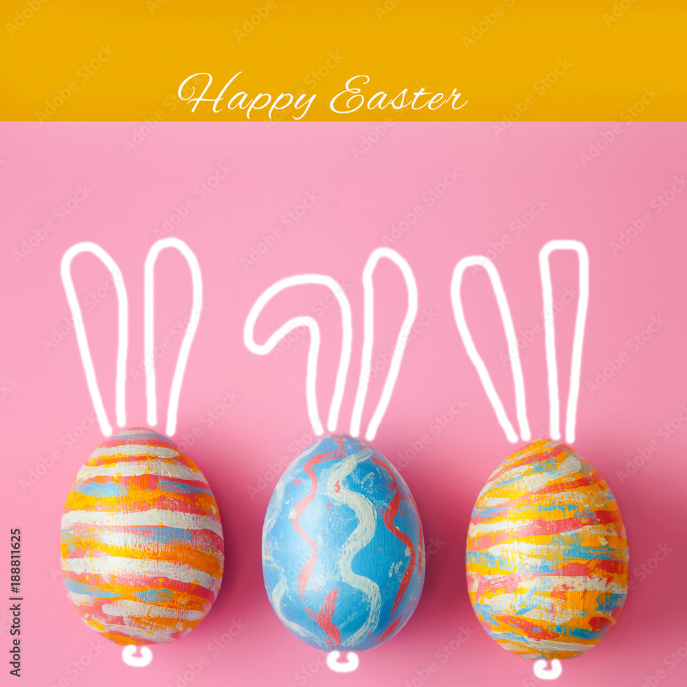 Easter colored eggs on a pink background, with painted hare ears. Background for a postcard, Easter concept, space for text Easter colored eggs on a pink background, with painted hare ears. Background for a postcard, Easter concept, space for text