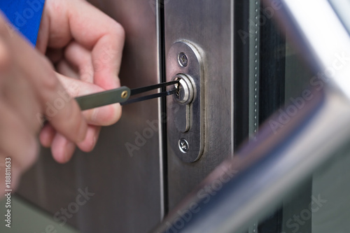 Person Opening Door With Lockpicker