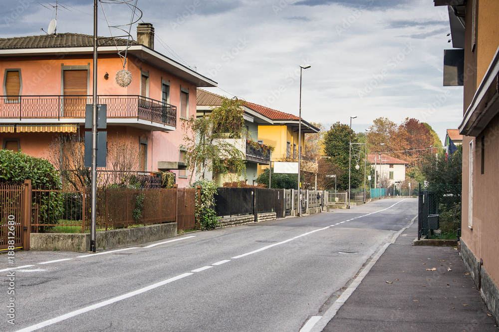 Empty road through residential area in Italy, Europe early in the morning. Empty road through residential area in Italy, Europe early in the morning.