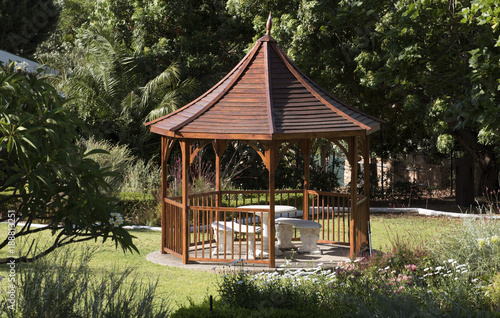 A pavilion style summer house situated in a large garden