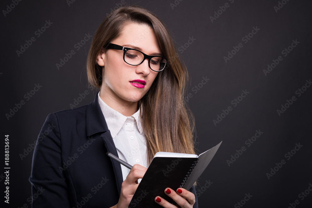 Attractive successful woman writing notes Attractive successful woman writing notes