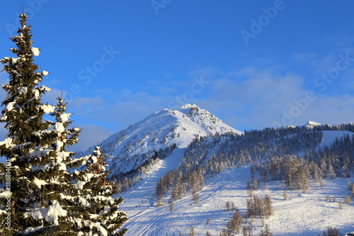Montgenevre. Winter landscape in French Alps. Mountain peaks and ski slopes on snow-covered hillside