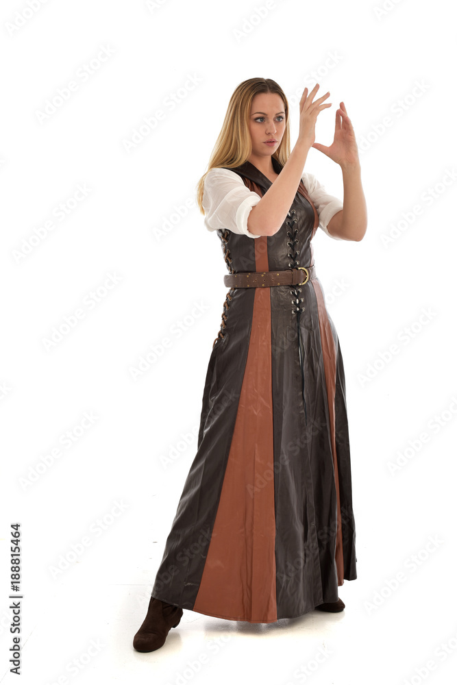 full length portrait of girl wearing brown fantasy costume. standing pose on white studio background. full length portrait of girl wearing brown fantasy costume. standing pose on white studio background.
