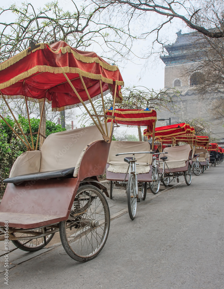 Rickshaw’s park in the early morning around the famous Bell tower in Beijing, China