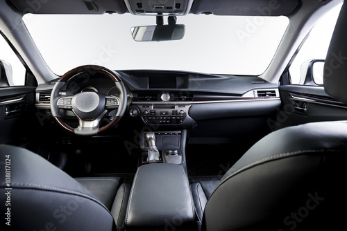 Dark luxury car Interior - steering wheel, shift lever and dashboard. Car inside. Beige comfortable seats, steering wheel, dashboard, climate control, speedometer, display. © gargantiopa