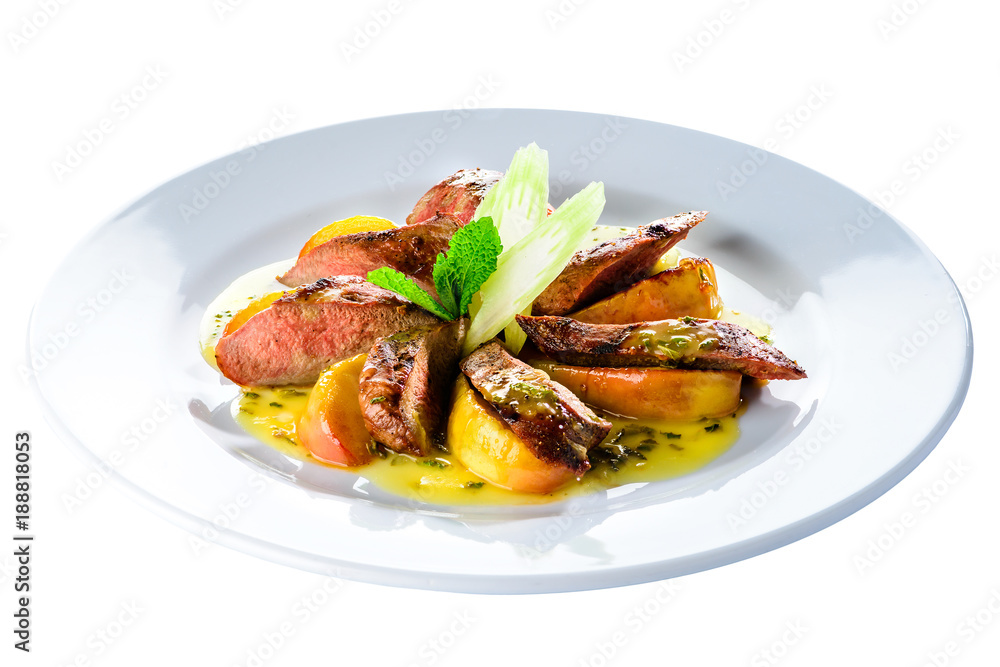 Juicy roasted appetizing golden crispy duck fillet served with baked apples in a white plate Juicy roasted appetizing golden crispy duck fillet served with baked apples in a white plate