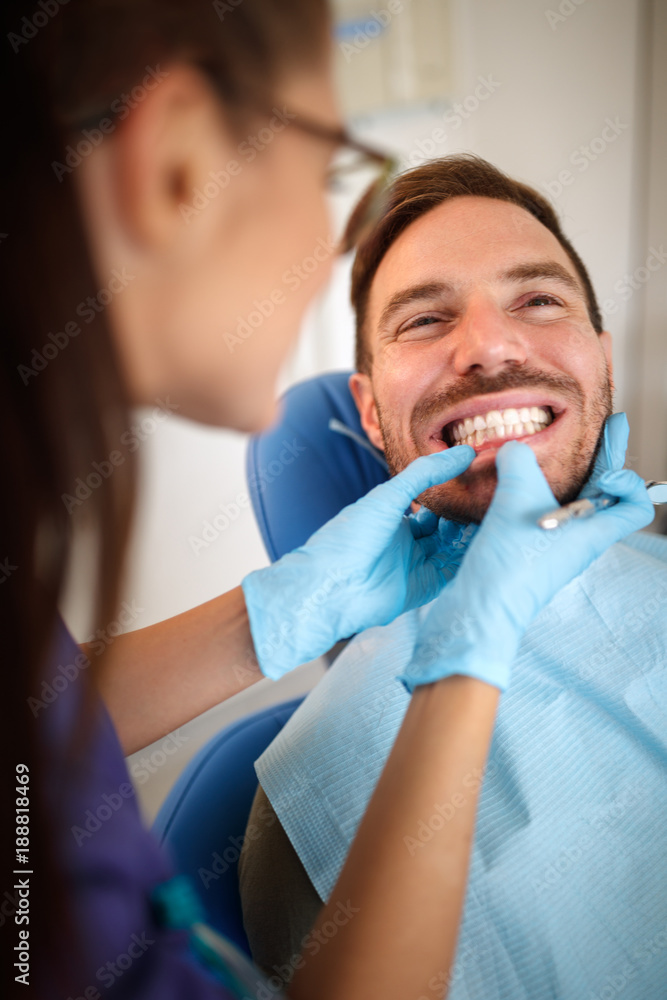 Orthodontist in dental clinic looking patient's bite Orthodontist in dental clinic looking patient's bite