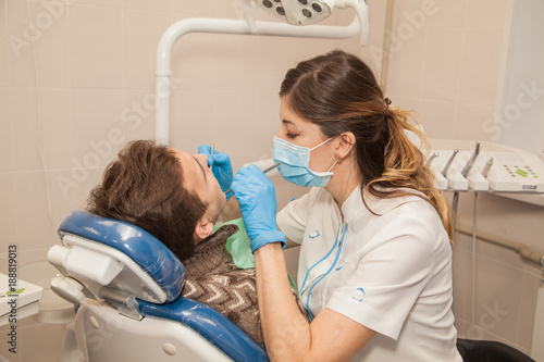 A woman doctor dentist in the office communicates with the patient. Stomatology. Medicine.