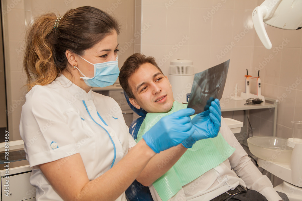 A woman doctor dentist in the office communicates with the patient. Stomatology. Medicine. A woman doctor dentist in the office communicates with the patient. Stomatology. Medicine.